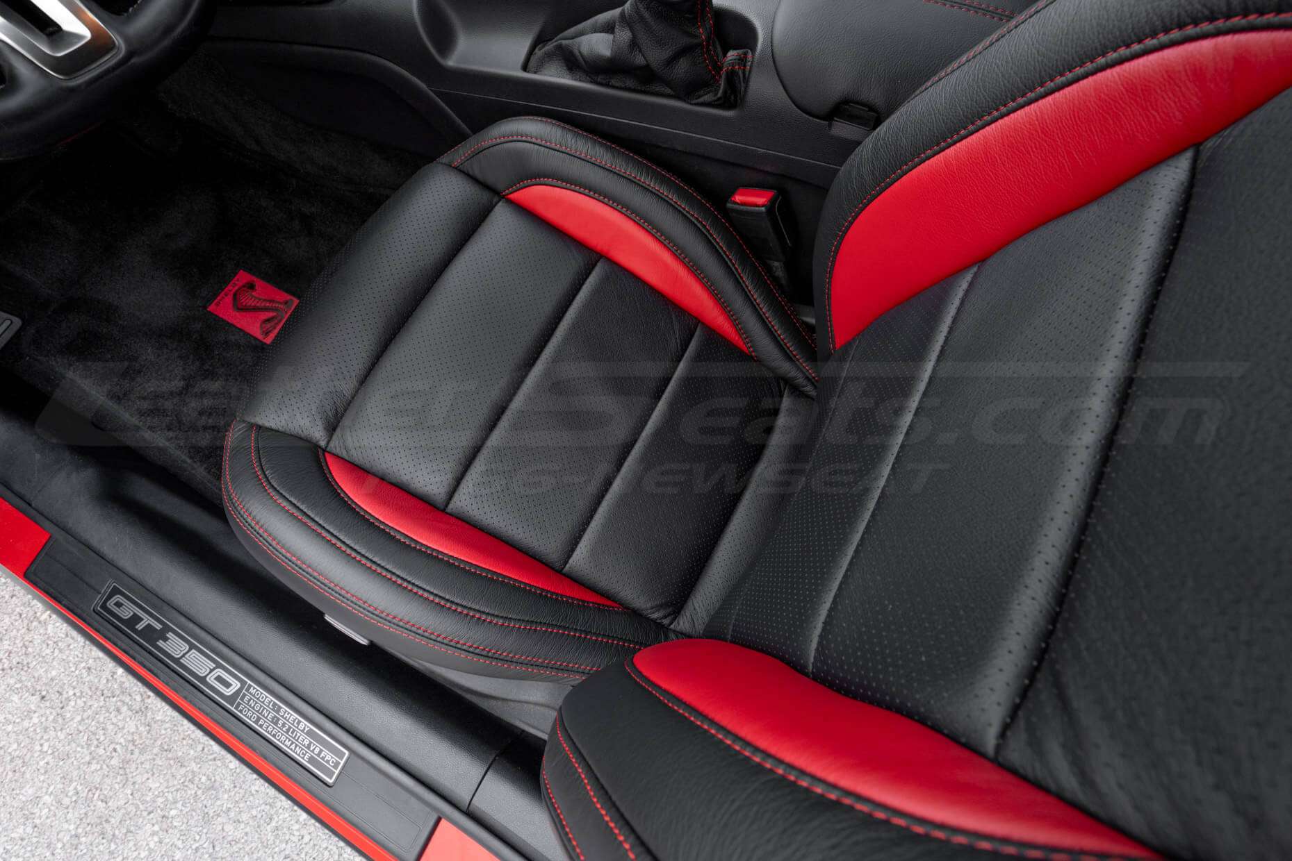 Top down view of front driver leather seat with perforated inserts