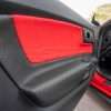 Close-up of driver side door panel insert in Bright Red & Black