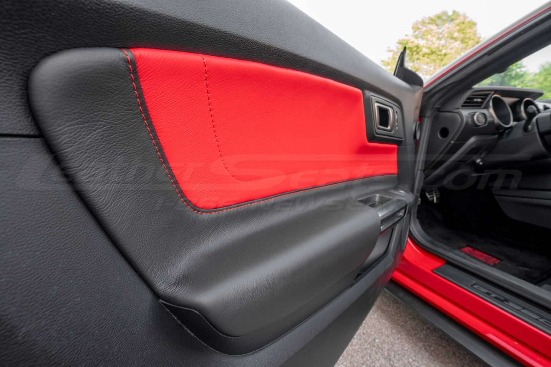 Close-up of driver side door panel insert in Bright Red & Black