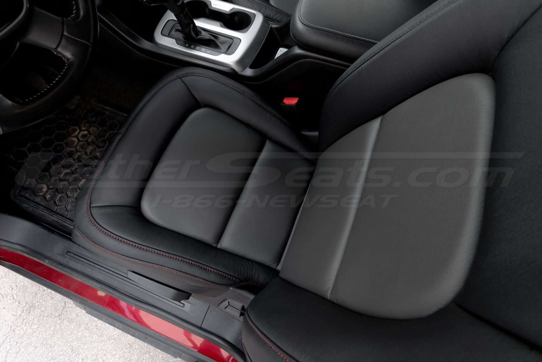 Top-down view of front driver seat showing graphite inserts