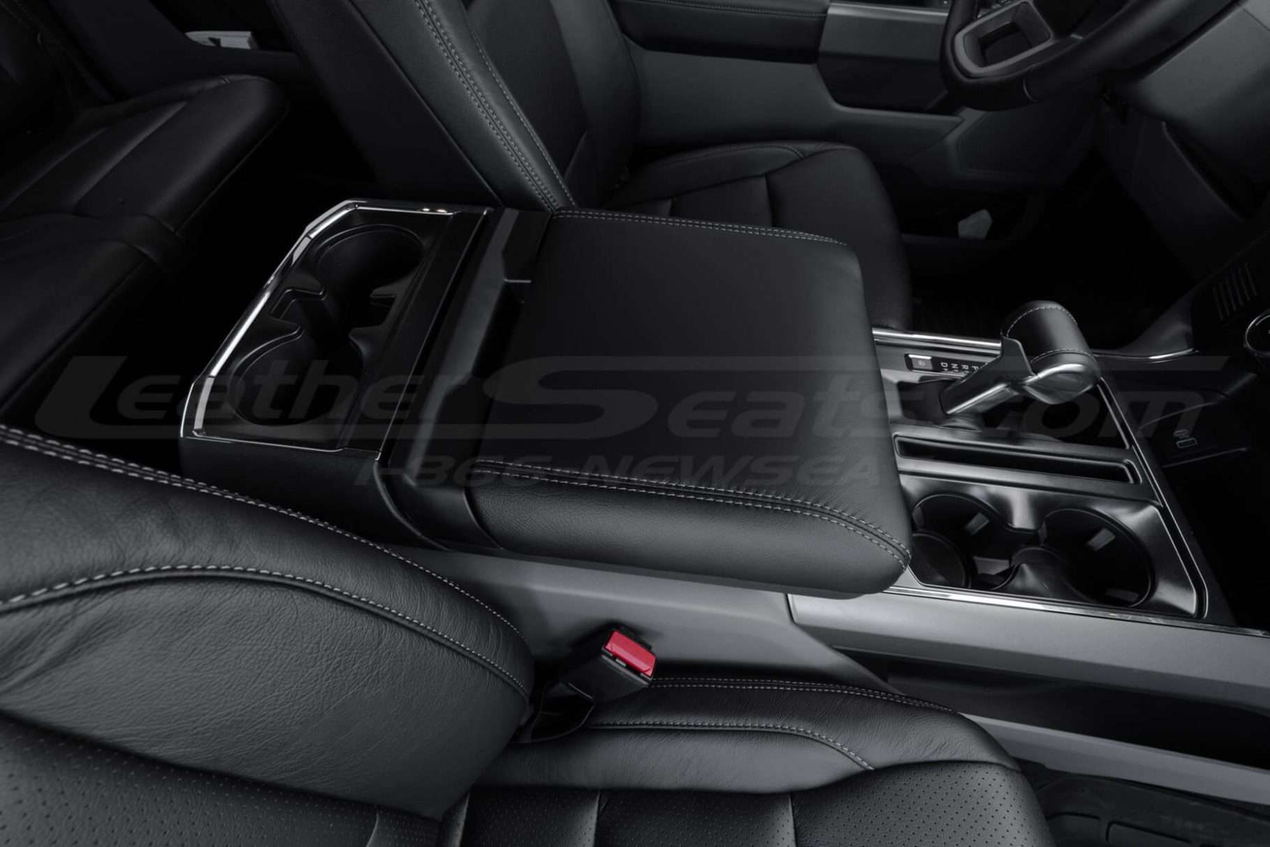 Passenger side view of installed black leather console lid cover