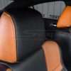 Two-Tone leather headrest with contrasting Orange stitching