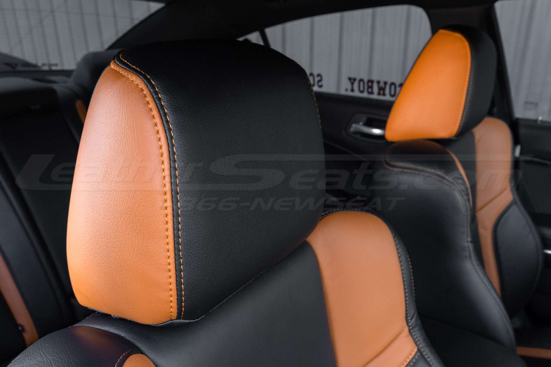 Two-Tone leather headrest with contrasting Orange stitching
