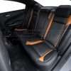 Driver side view of custom two-tone leather rear seats