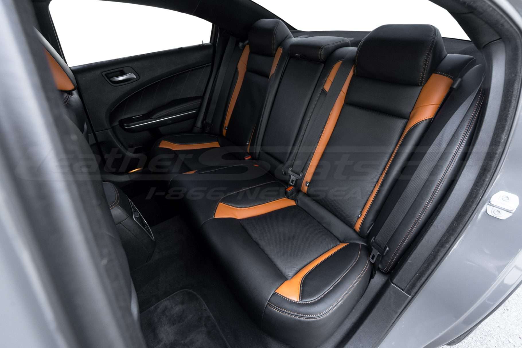 Driver side view of custom two-tone leather rear seats