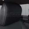 Black leather headrest close-up with contrasting Platinum stitching