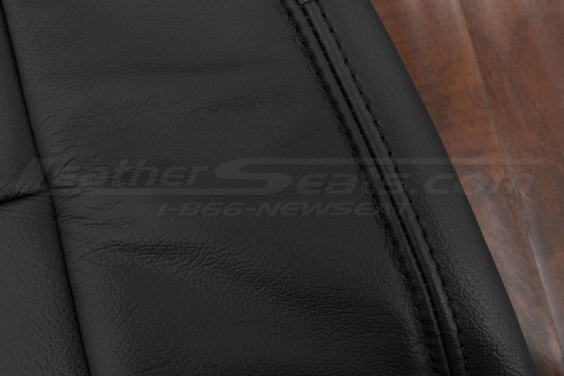 Black double-stitching on black leather