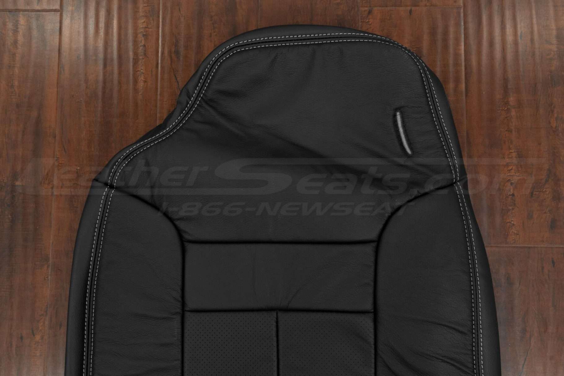 Driver headrest section of Dodge Ram black backrest upholstery