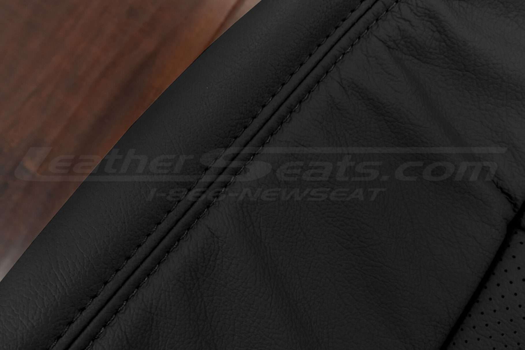 Black double-stitching on black leather