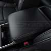 Drive side close-up of Toyota Tacoma leather console lid cover in Black with Dove Grey thread