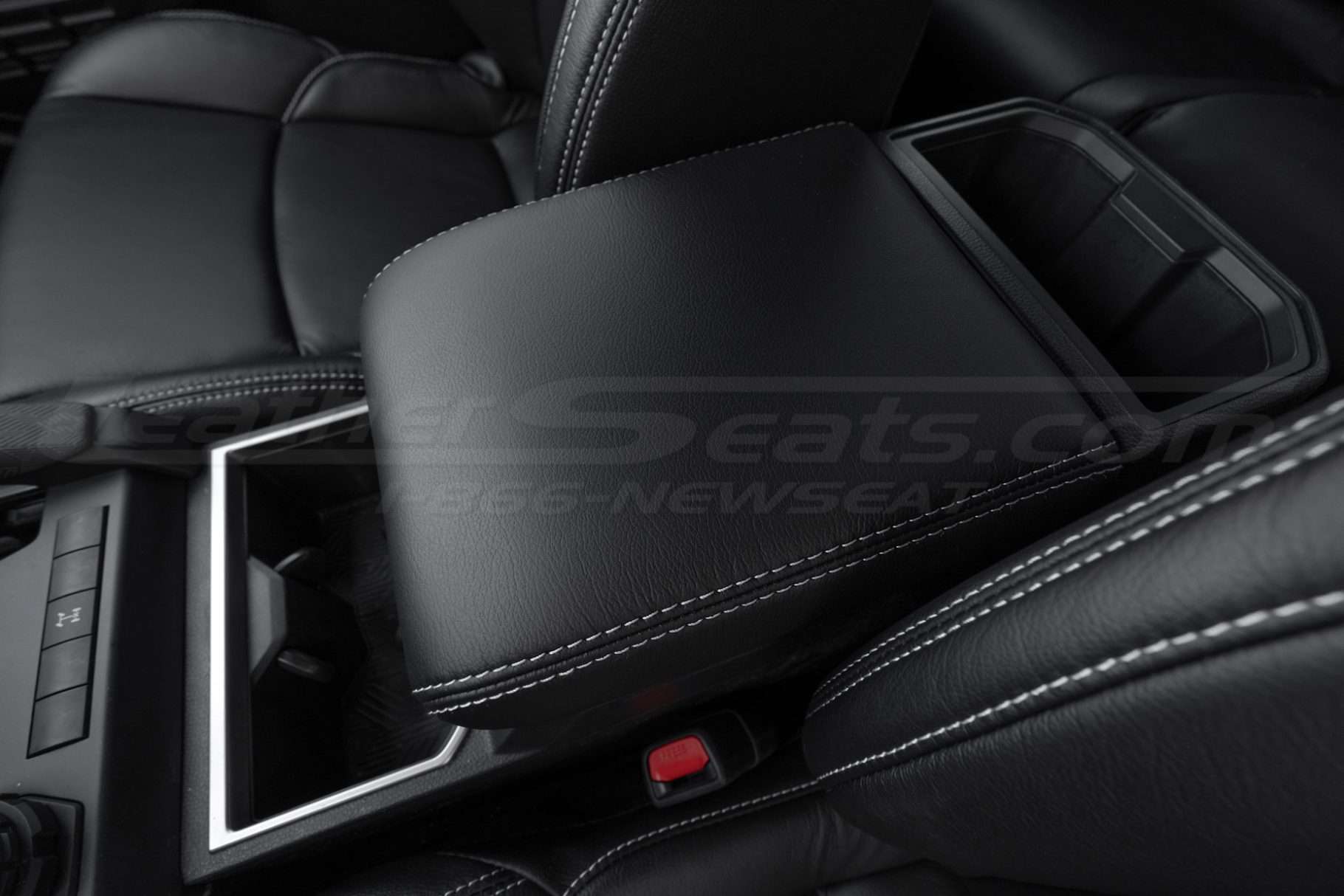Drive side close-up of Toyota Tacoma leather console lid cover in Black with Dove Grey thread