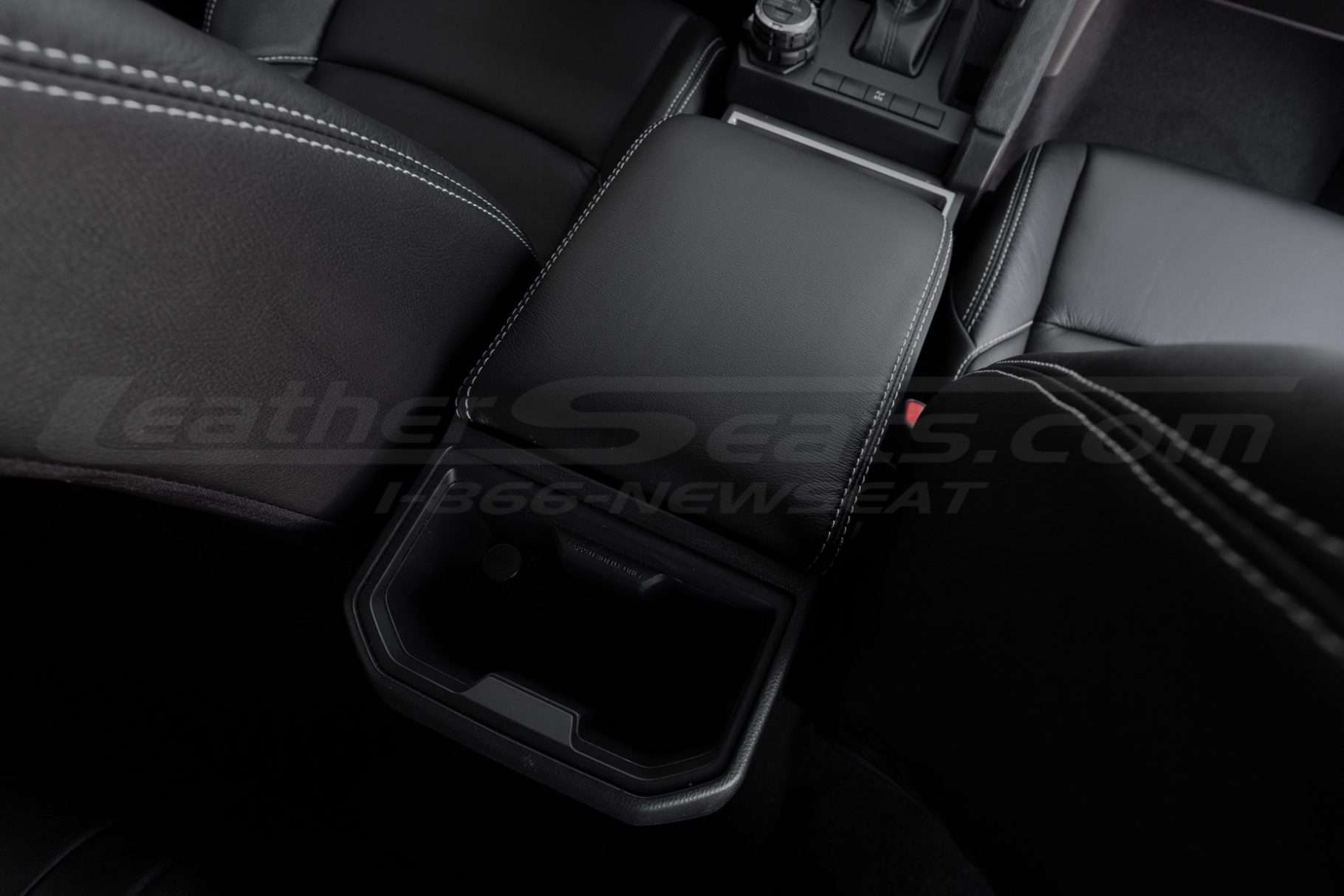 Side back view of 2024 Touta Tacoma leather console lid over