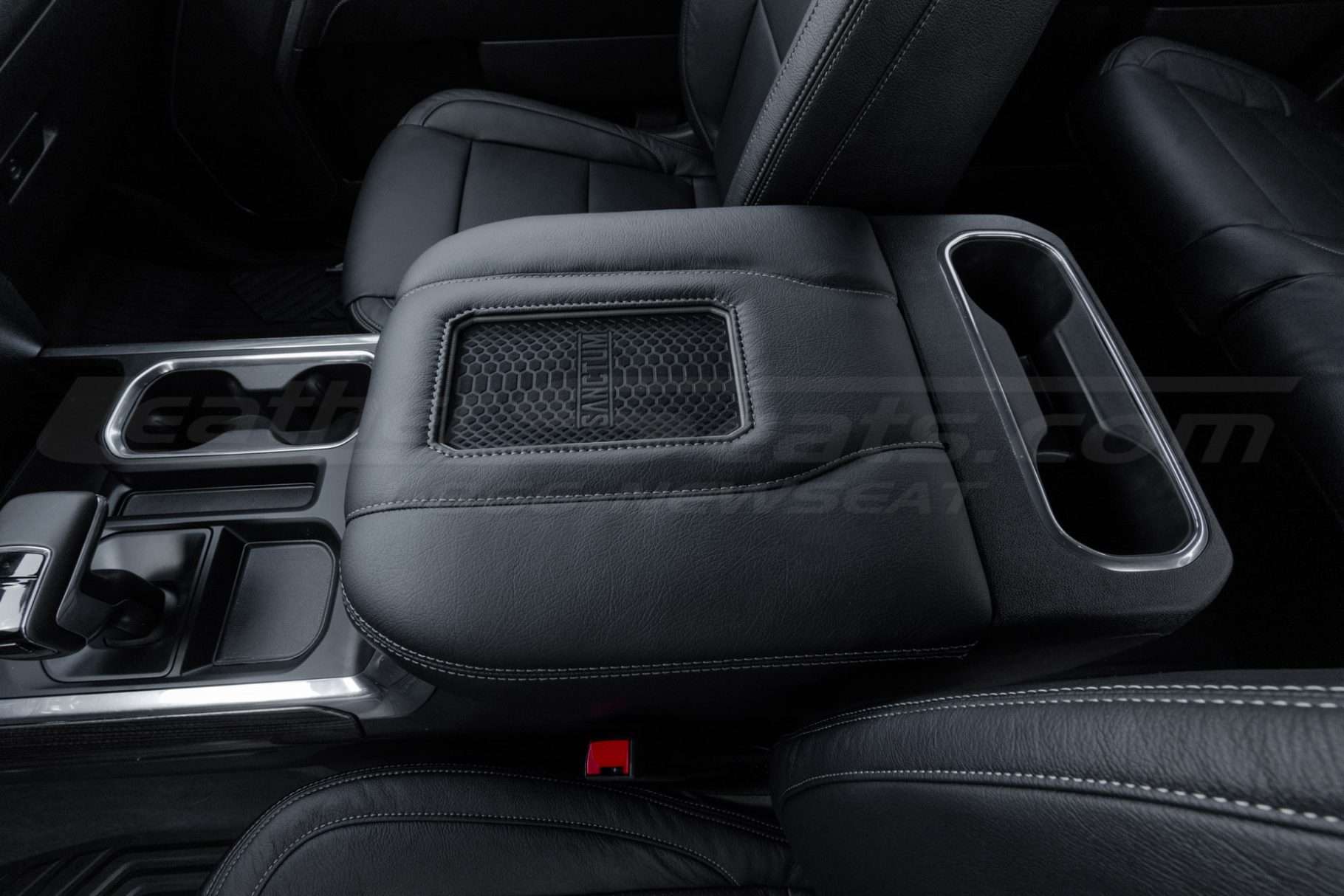 Driver side view of installed leather aftermaket phone charging console lid