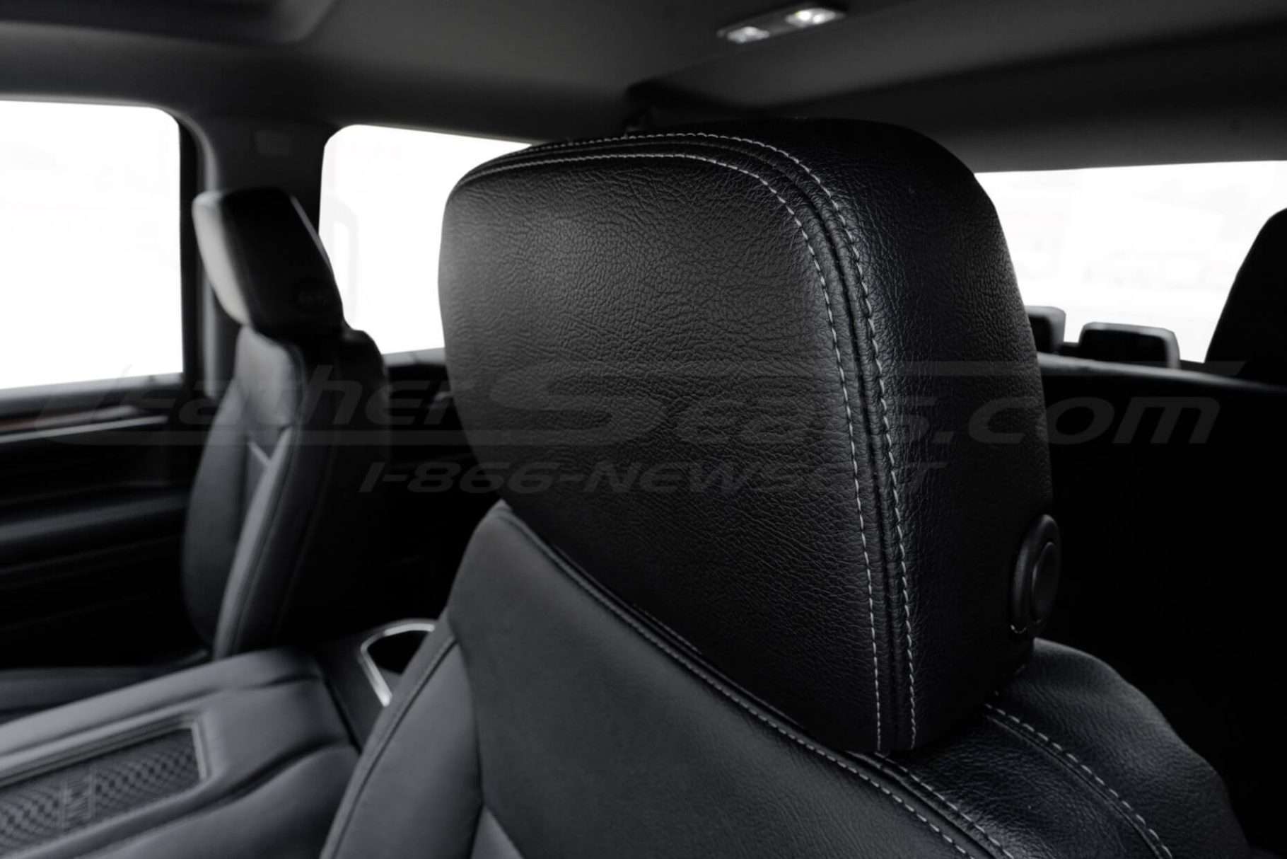 Black Silverado leather headrest close-up with contrasting Lapis double-stitching