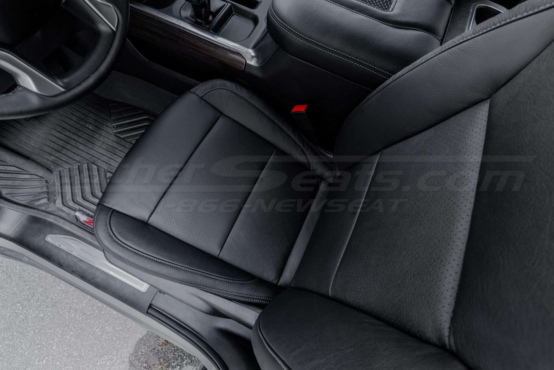 Top-down view of front driver leather seat with perforated inserts