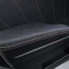 Black leather door armrest with contrasting orange stitching - front driver door installed