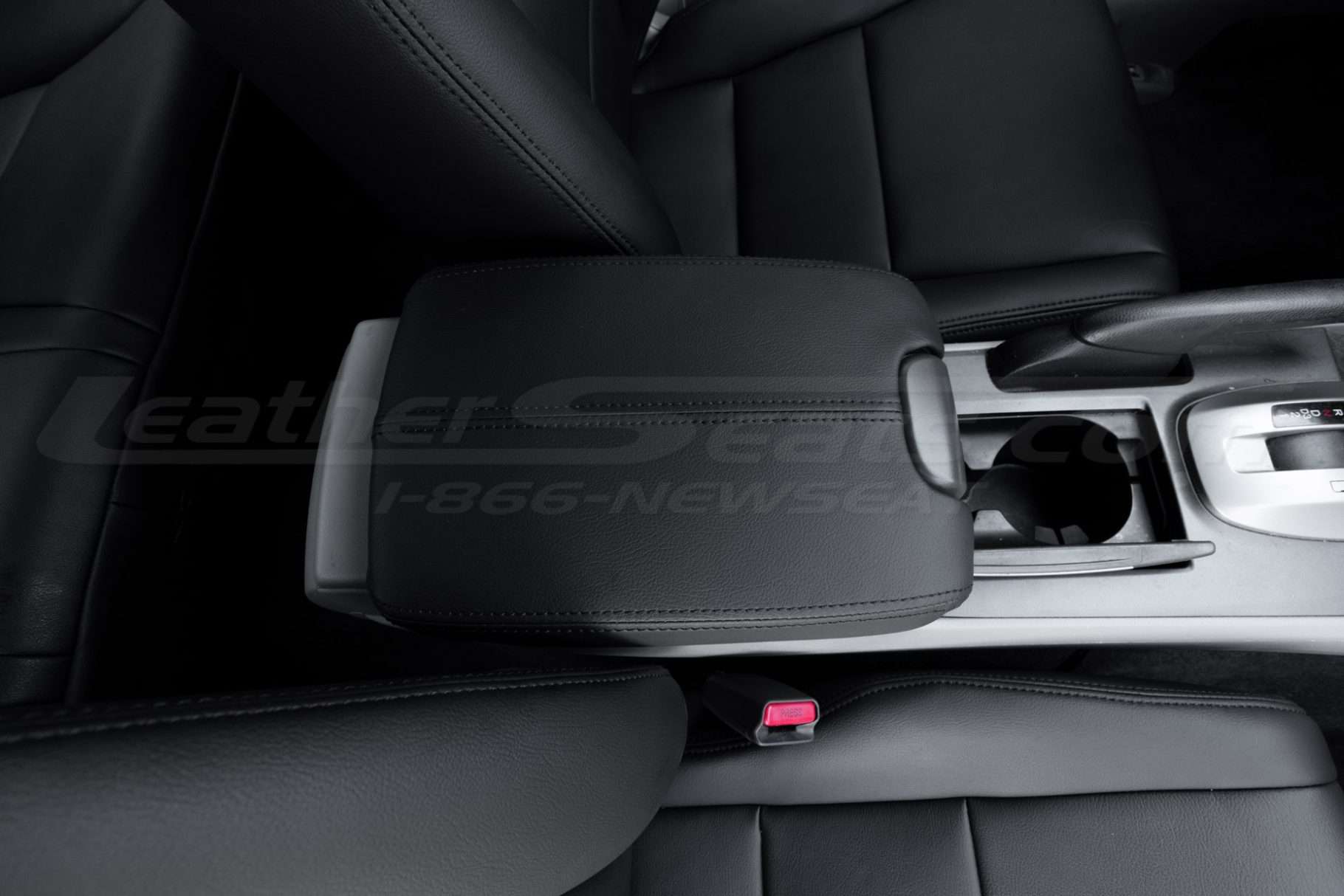Top-down view from passenger side of leather console lid with matching stitching