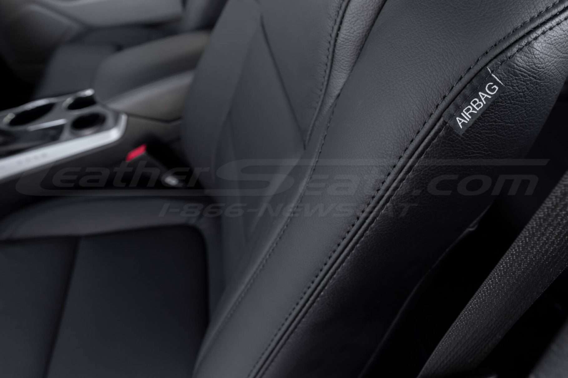 Black double-stitching on black leather with Airbag tag