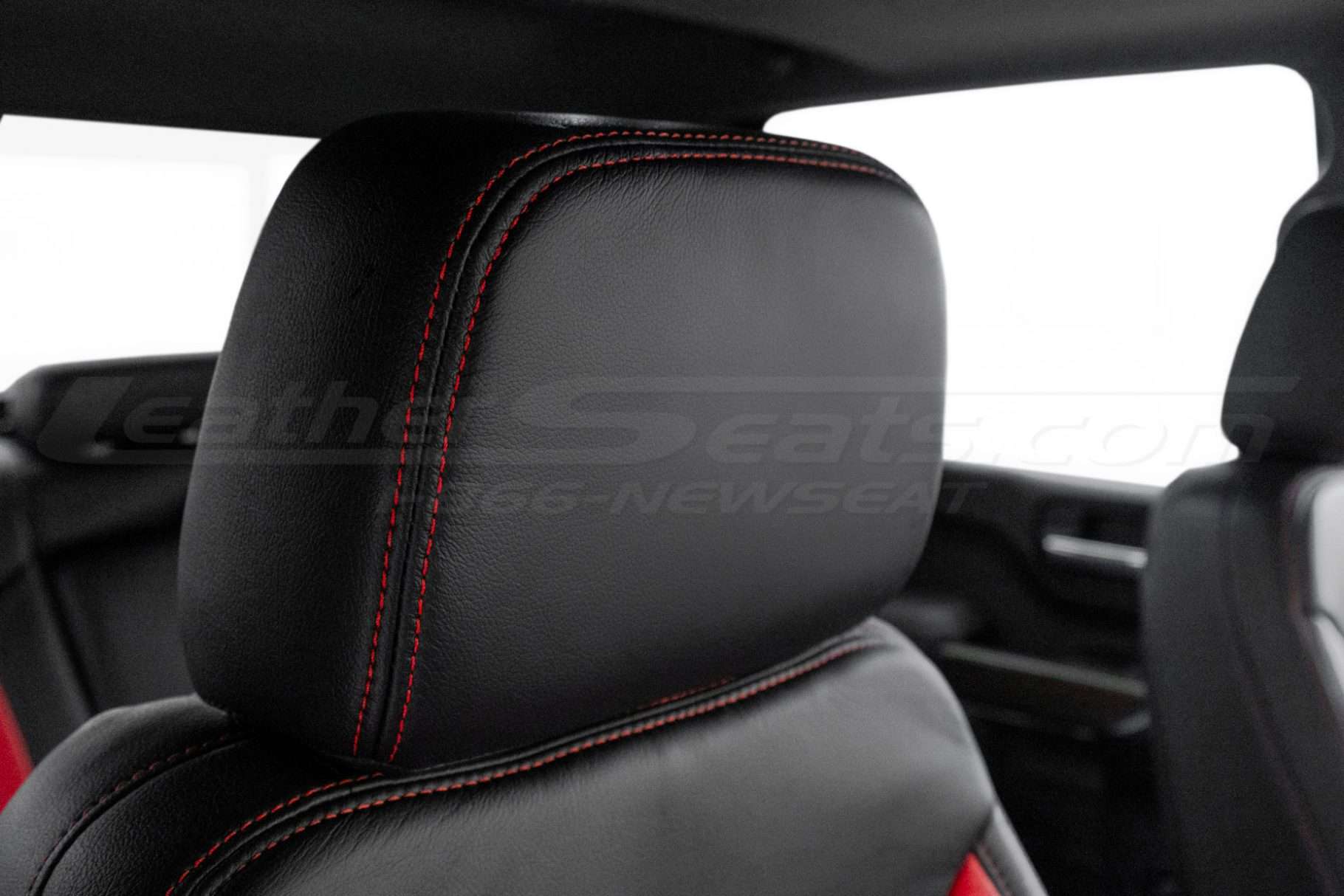 Black leather headrest with contrasting Bright Red stitching