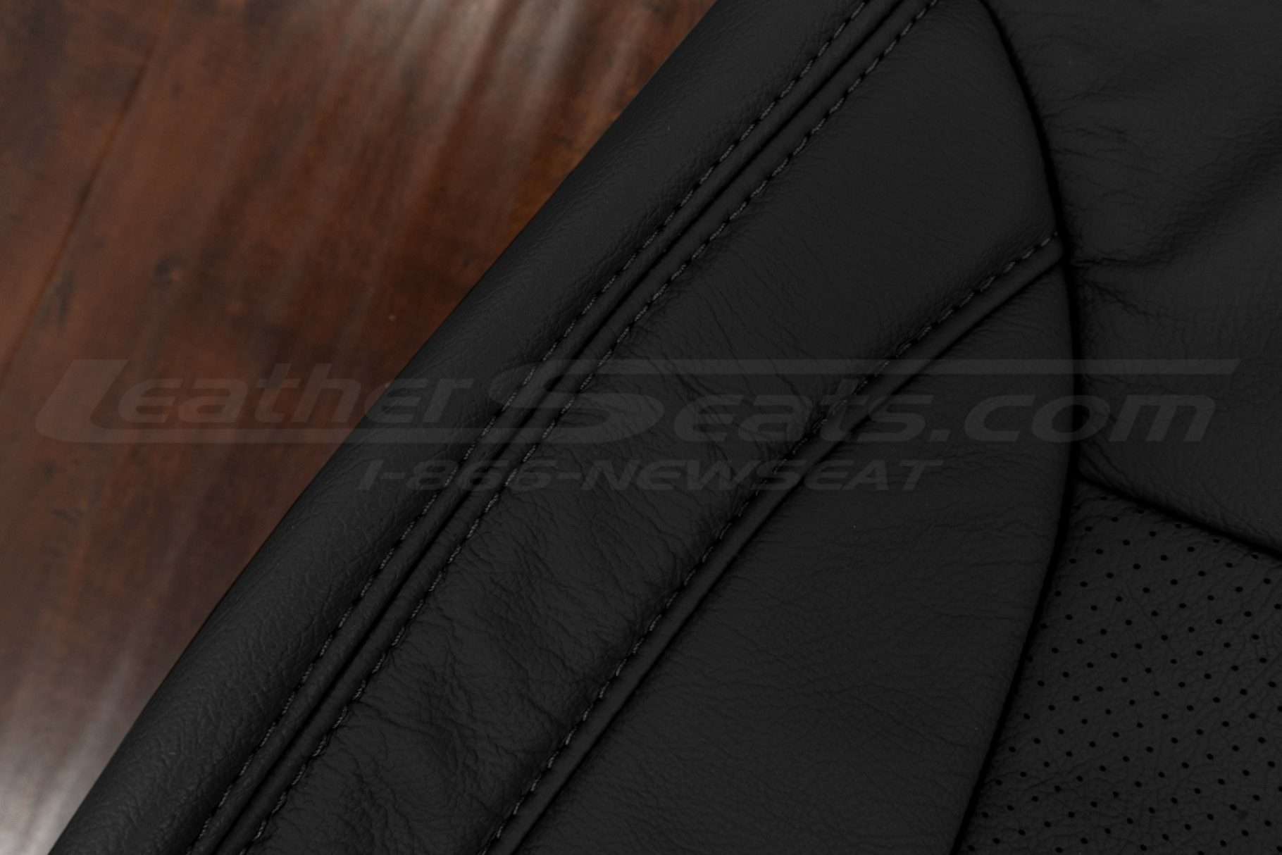 Black double-stitching on black leather