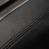Black double-stitching on black leather console cover