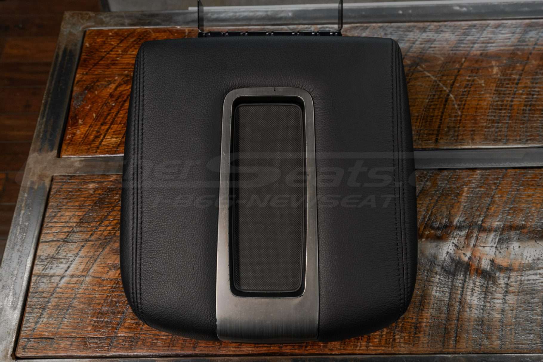 Top-down flat lay of Hummer H2 console lid cover in black leather
