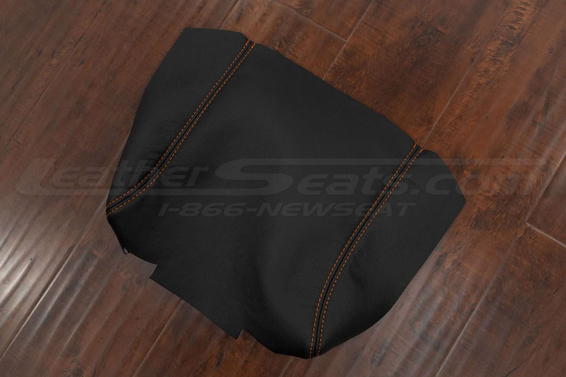 Aftermarket leather console lid cover in Black leather with citrus orange stitching