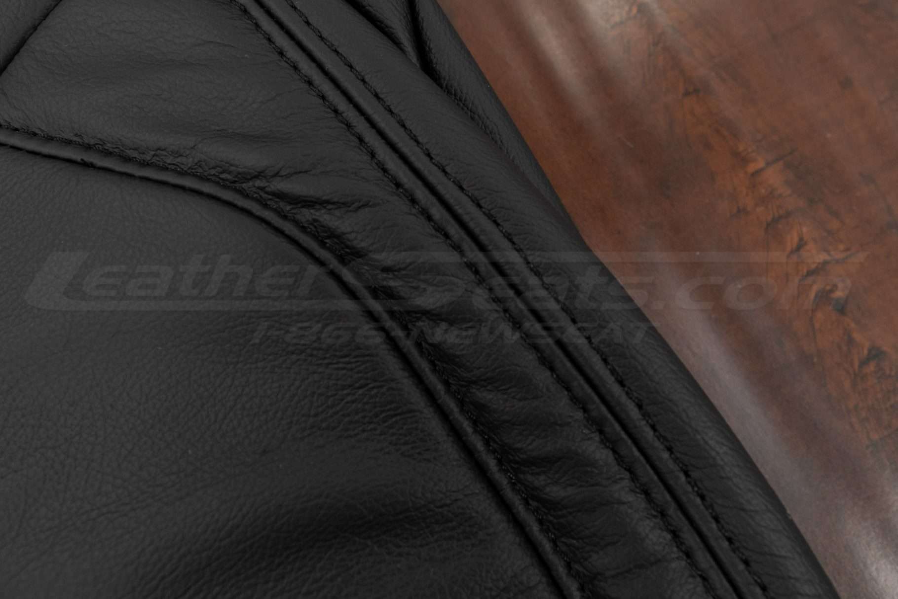 Black double-stitching on black leather
