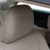 installed leather headrest with matching ivory stitching close-up