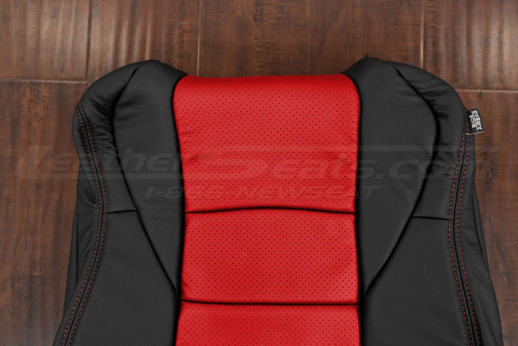 Upper section of leather backrest upholstery in black and bright red