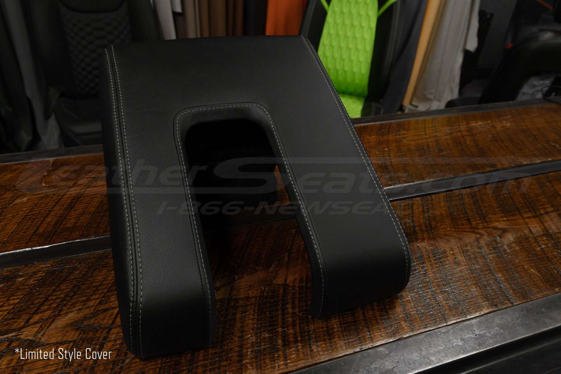 Alternate side angle view of limited style tundra console lid cover in black leather with contrasting stitching