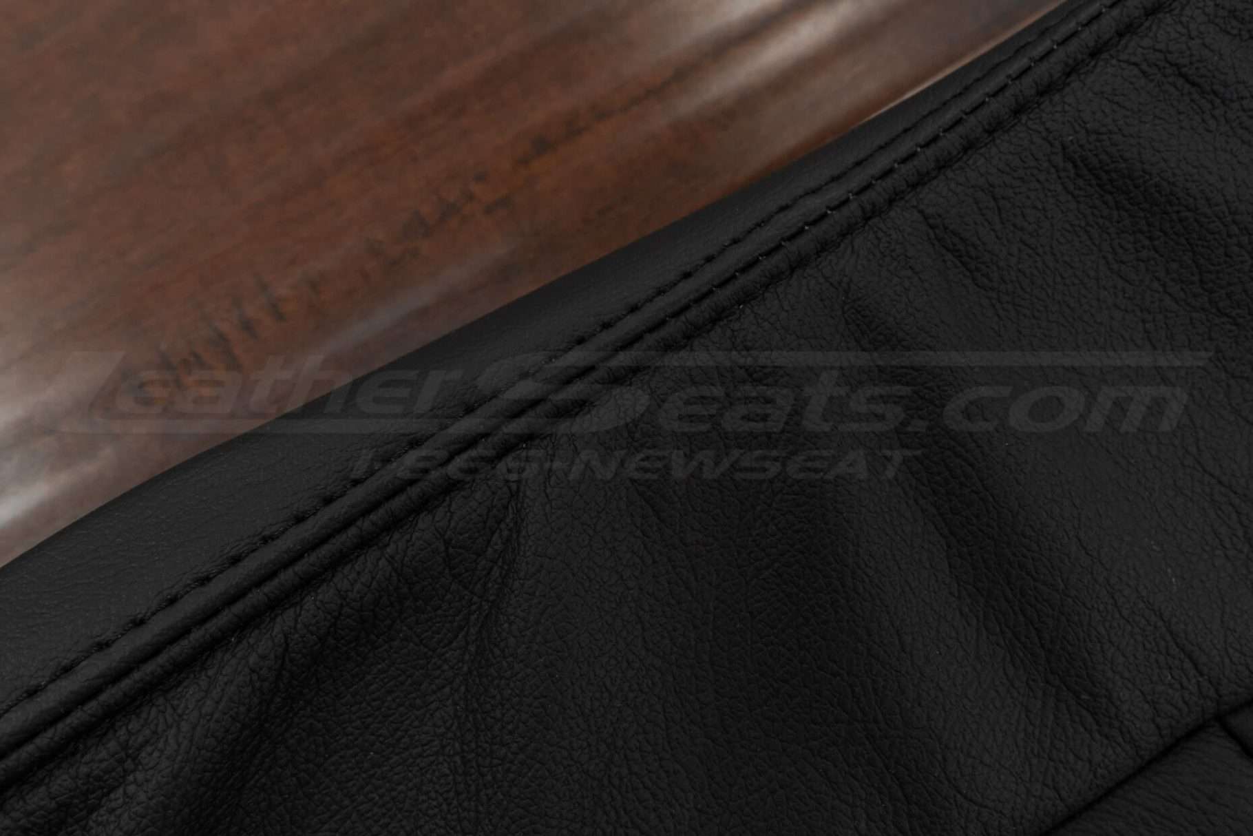 Black double-stitching on matching black leather