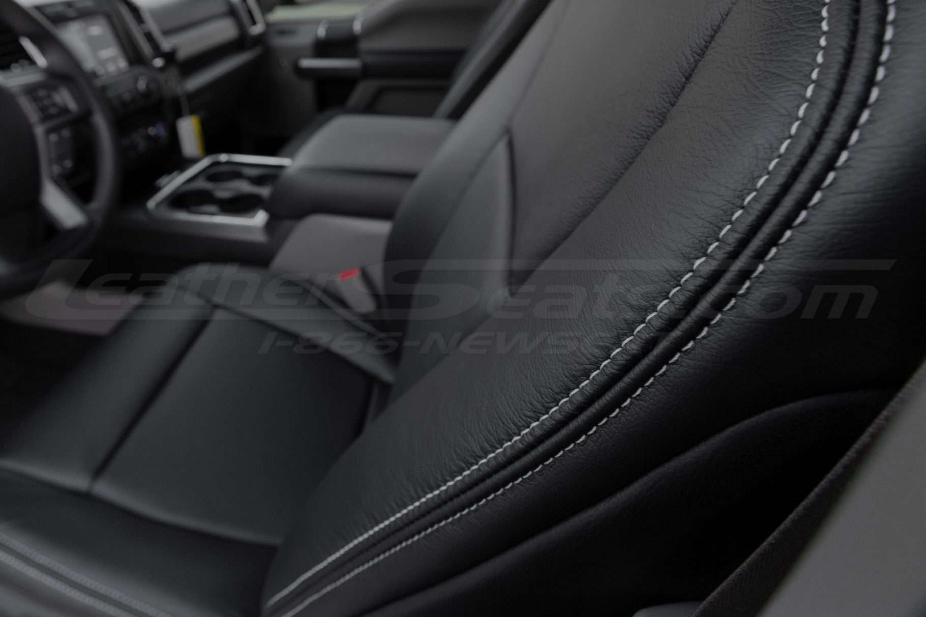 Contrast silver stitching on Black leather close-up