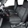 Ford Superduty aftermarket leather seat covers installed - Front driver seat with middle jump seat in sitting position