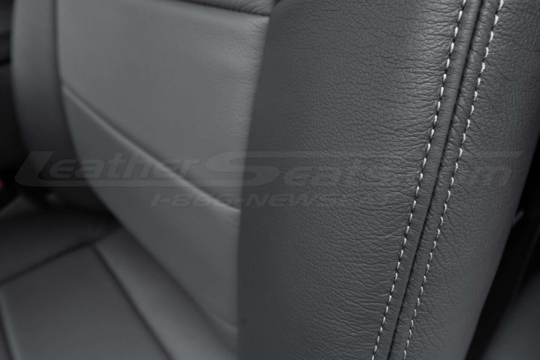 Contrasting light grey stitching on graphite bolster close-up