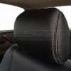 Black leather headrest with contrast adobe double-stitching close-up