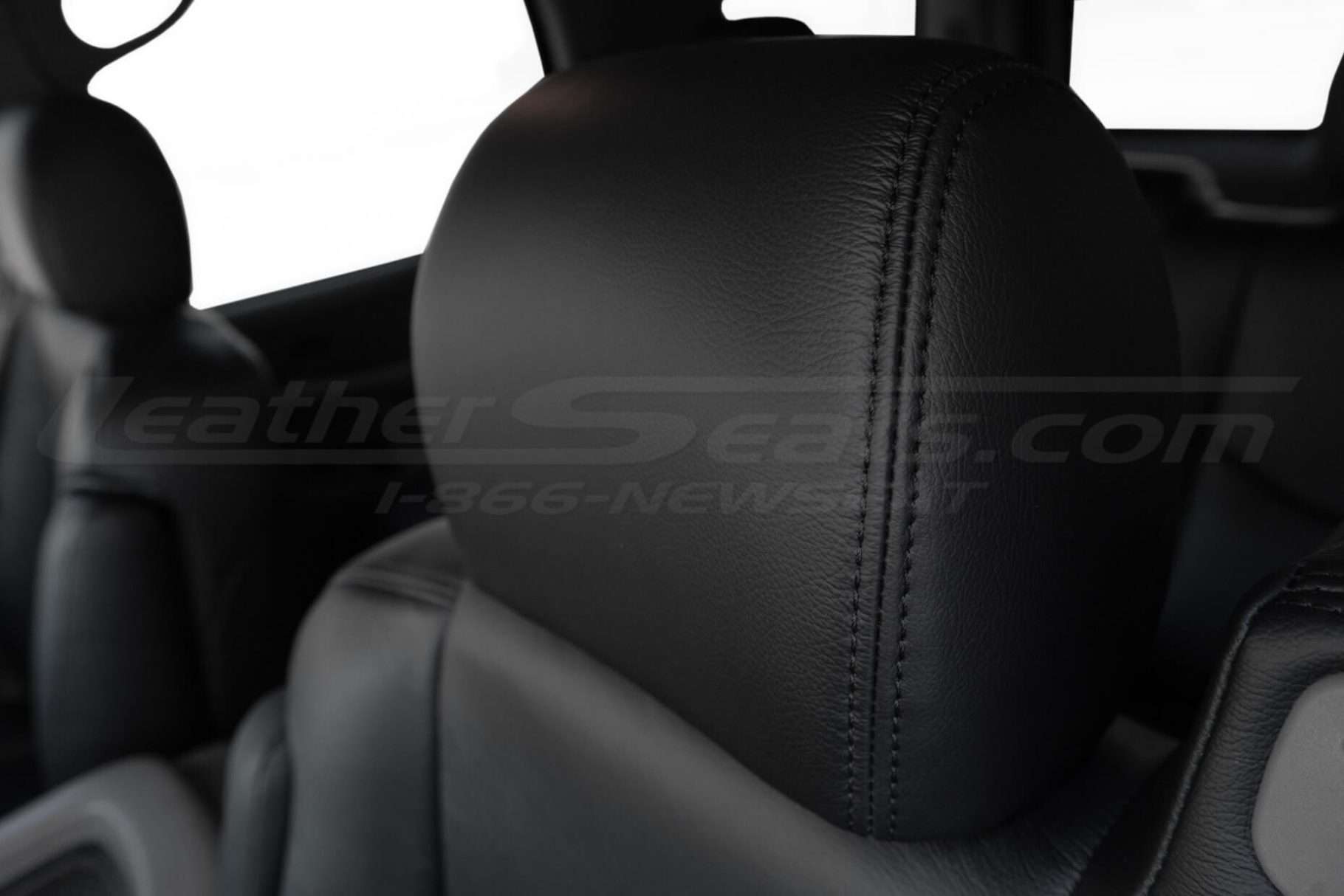 Installed Black leather headrest with matching Black double-stitching close-up