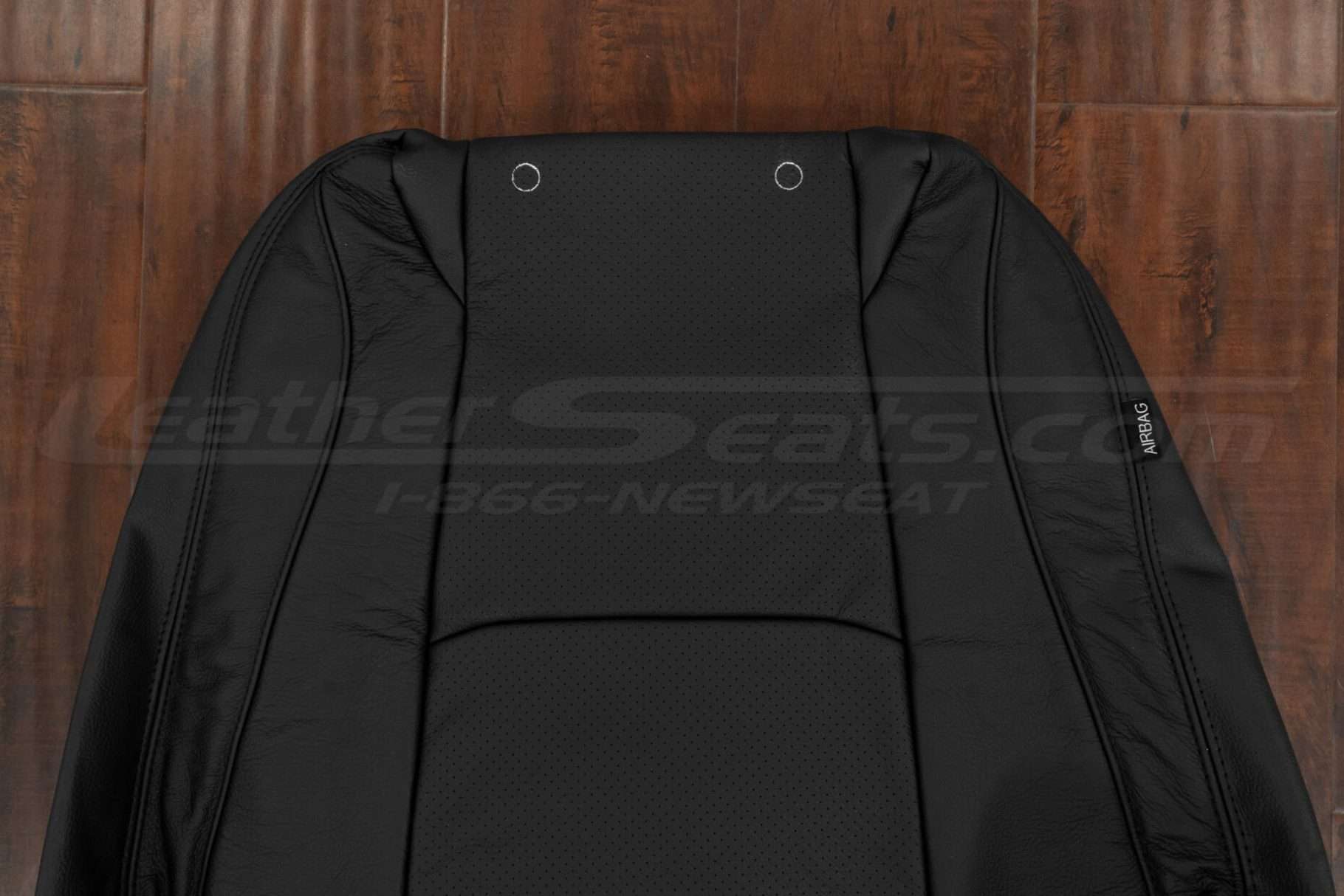 Upper section of leather backrest upholstery with perforated body section