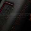 Red double-stitching close-up on aftermarket leather console lid