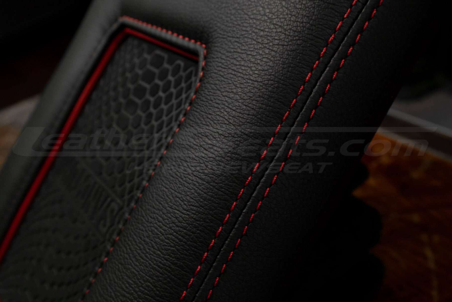 Red double-stitching close-up on aftermarket leather console lid