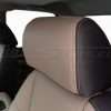 Two-Tone installed leather headrest close-up with contrast sandstone double stitching