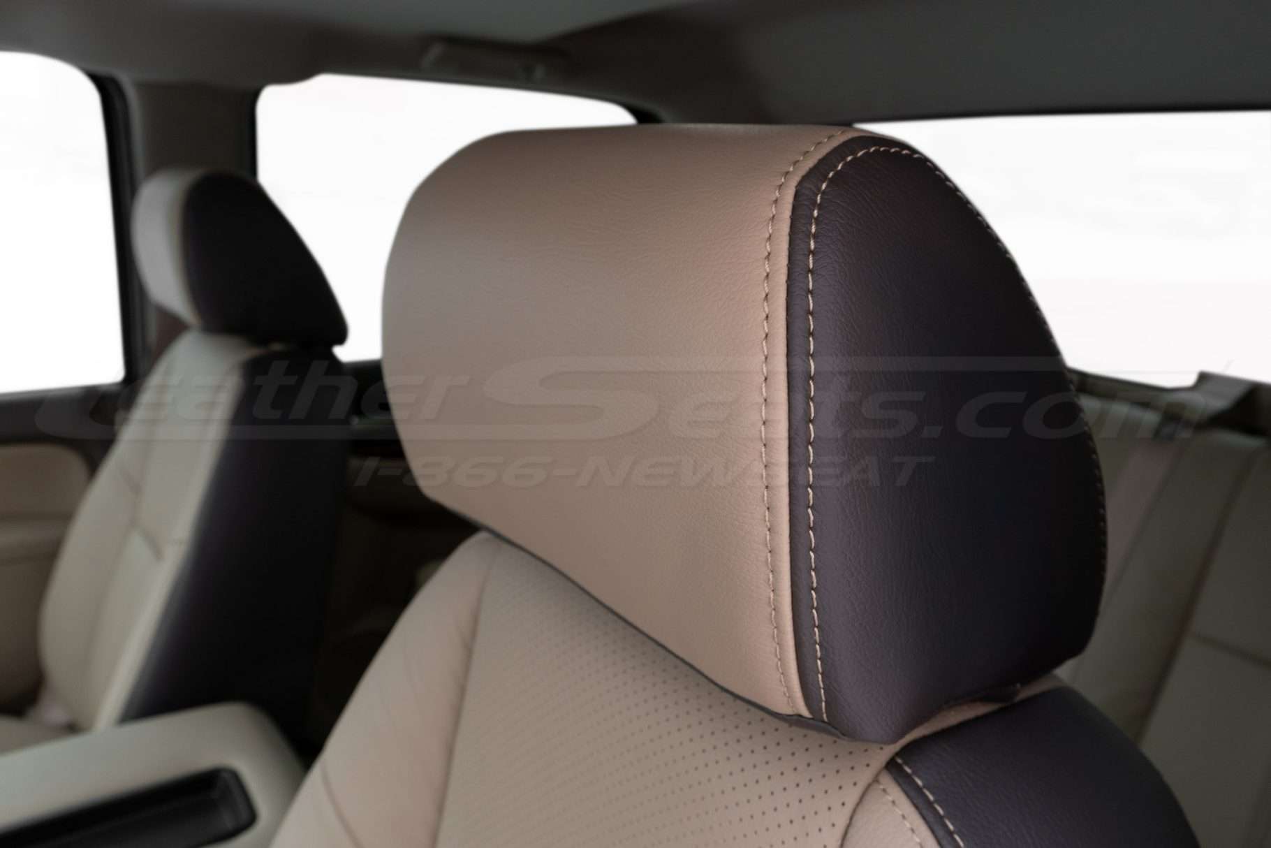 Two-Tone installed leather headrest close-up with contrast sandstone double stitching
