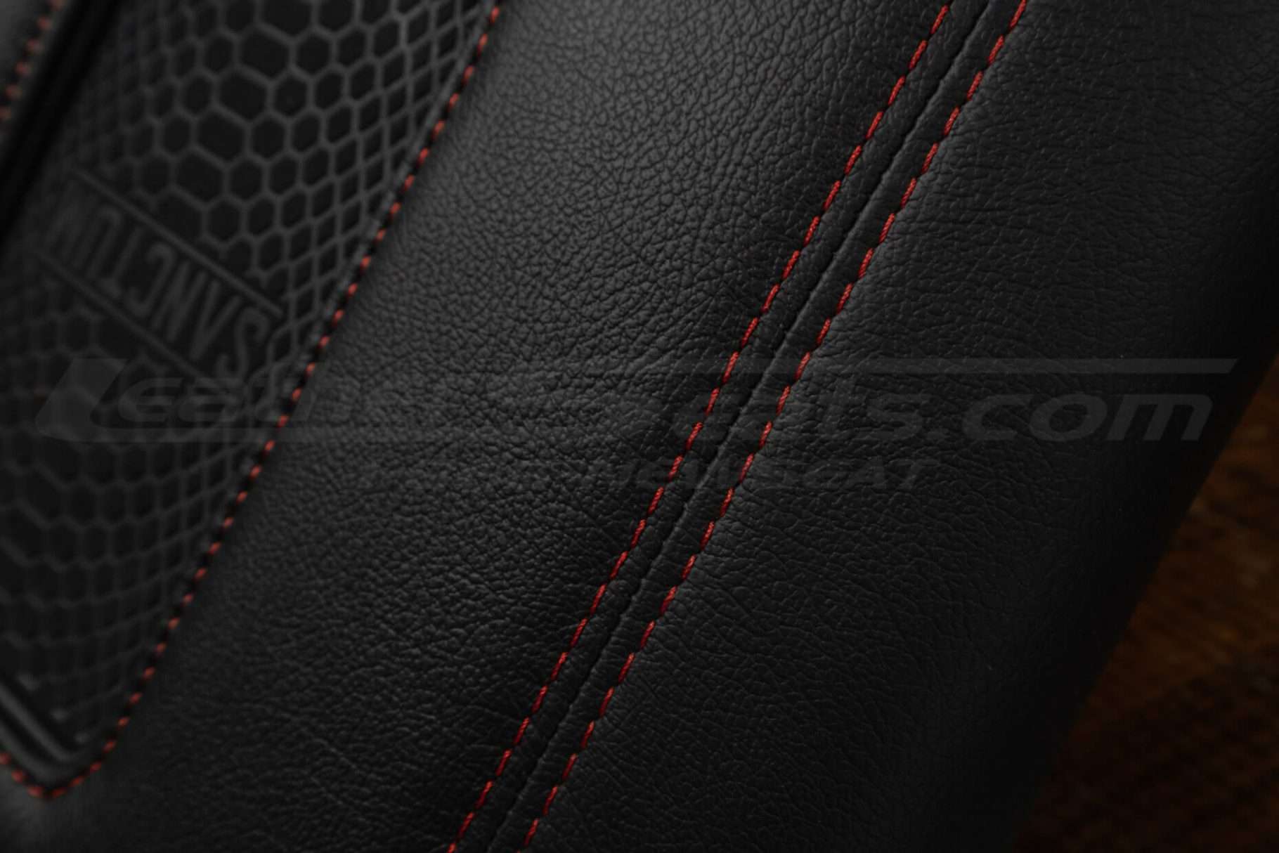 Red double-stitching on console lid close-up