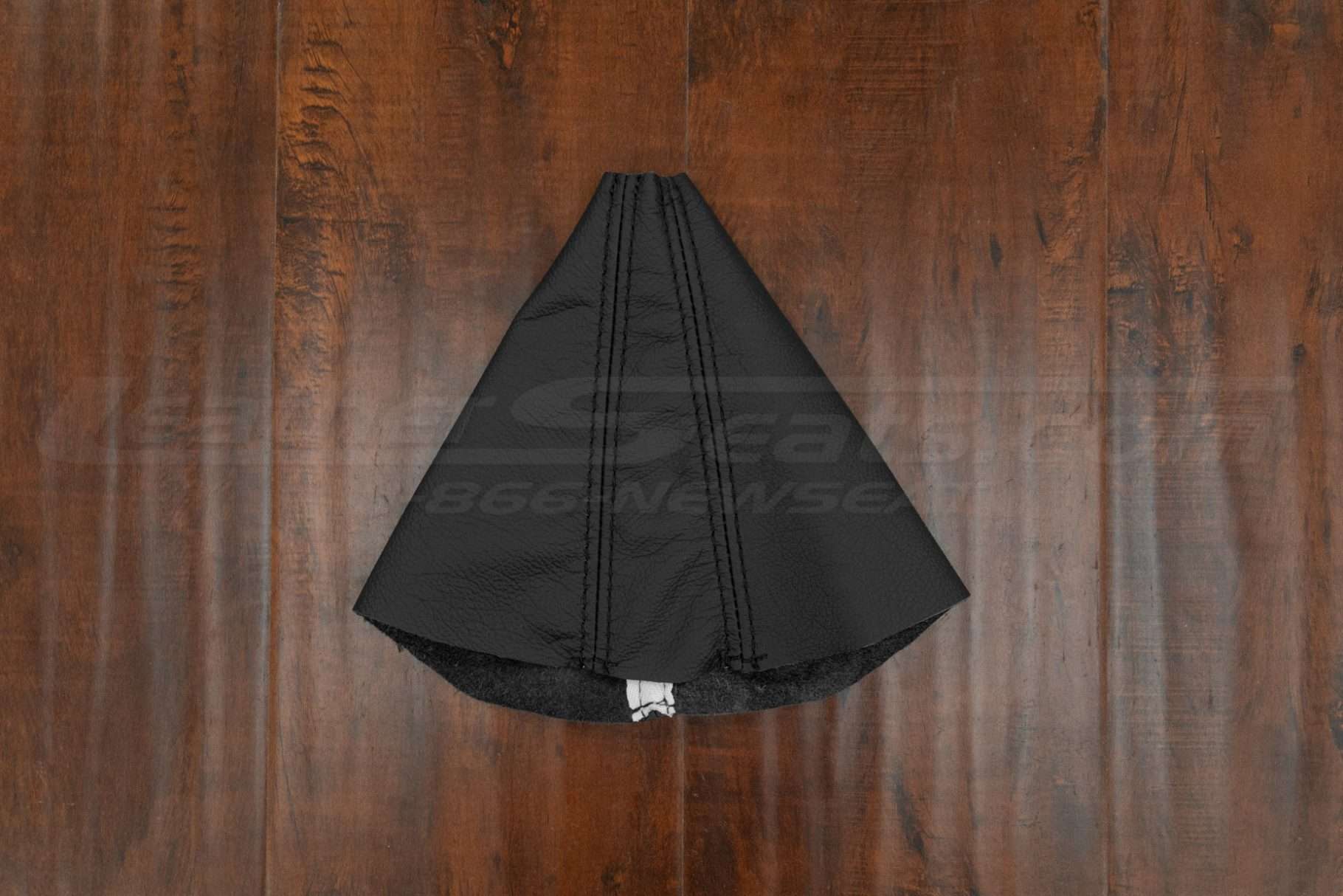 Flat lay of camaro leather shift boot upholstery in black