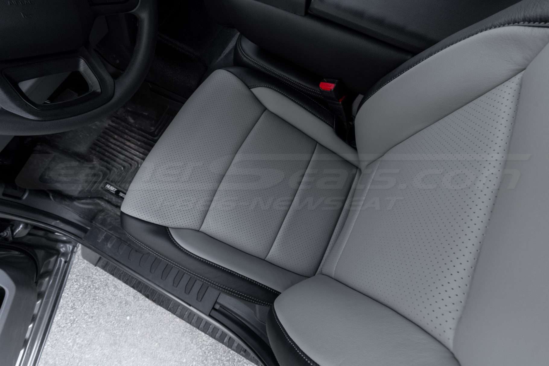 Top-down view of front driver seat with perforated combo section