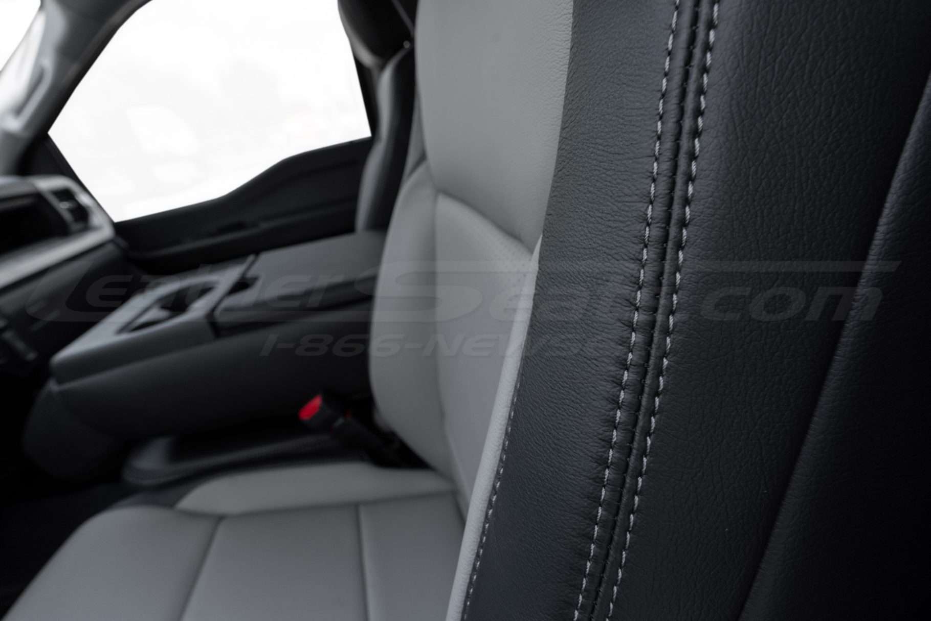 Contrasting ash double-stitching on Black leather side bolster