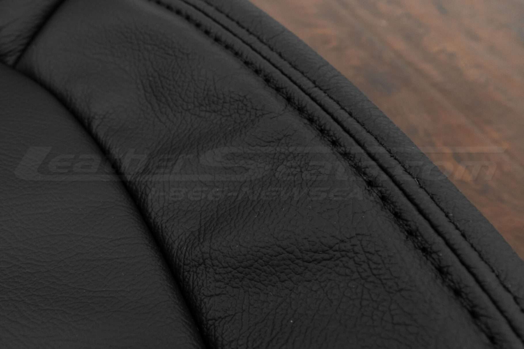 Matching Black double-stitching on black leather close-up