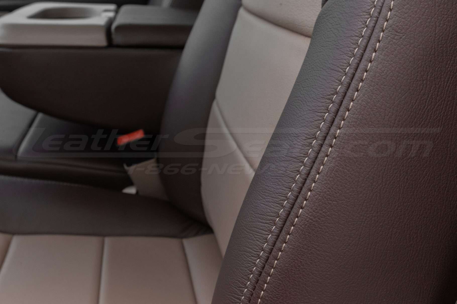 Contrasting adobe stitching on coffee leather close-up