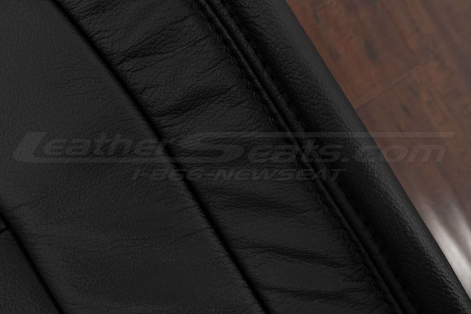 Black double-stitching on black leather