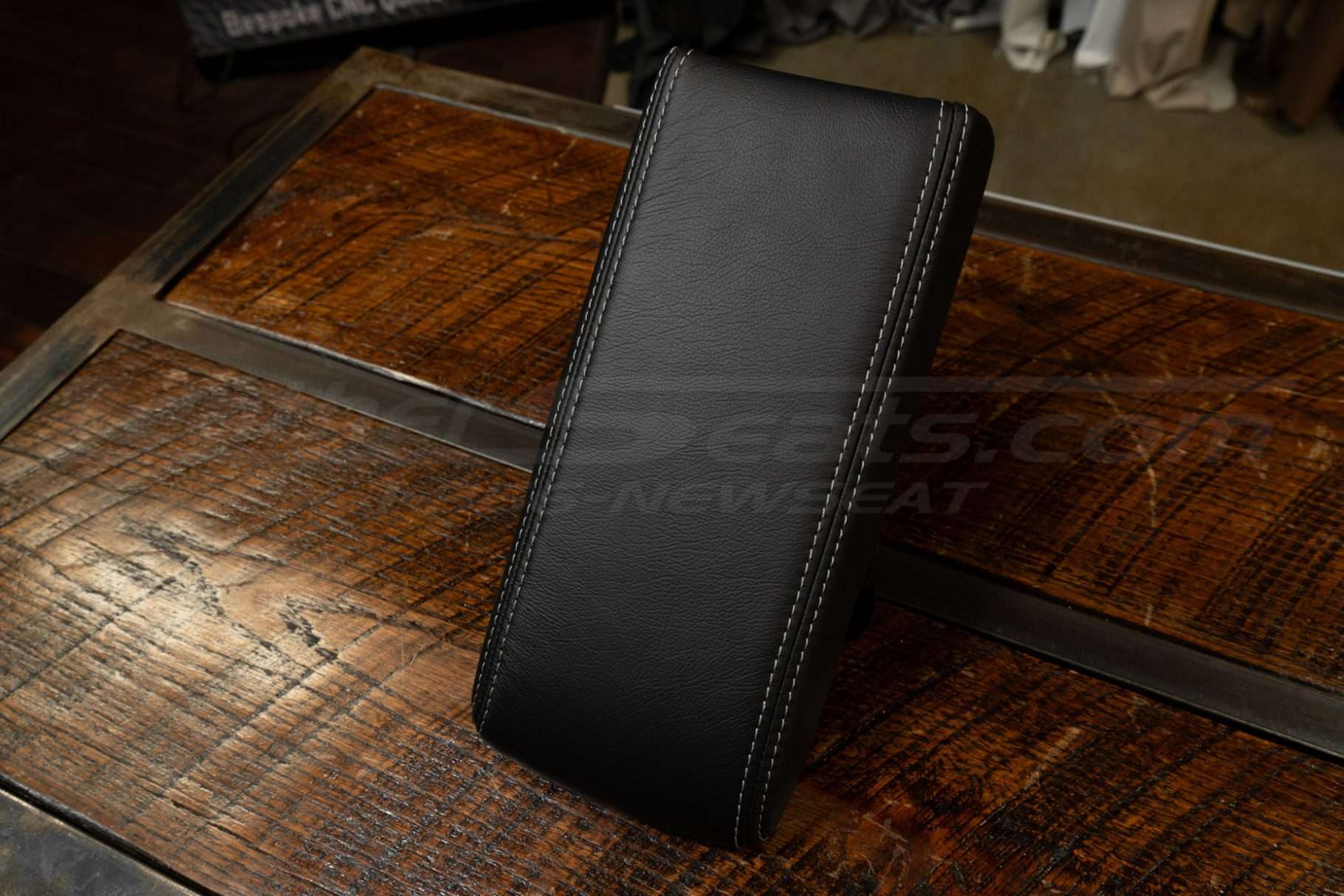 Top-down side view of installed premium leather console lid cover for acura legend coupe